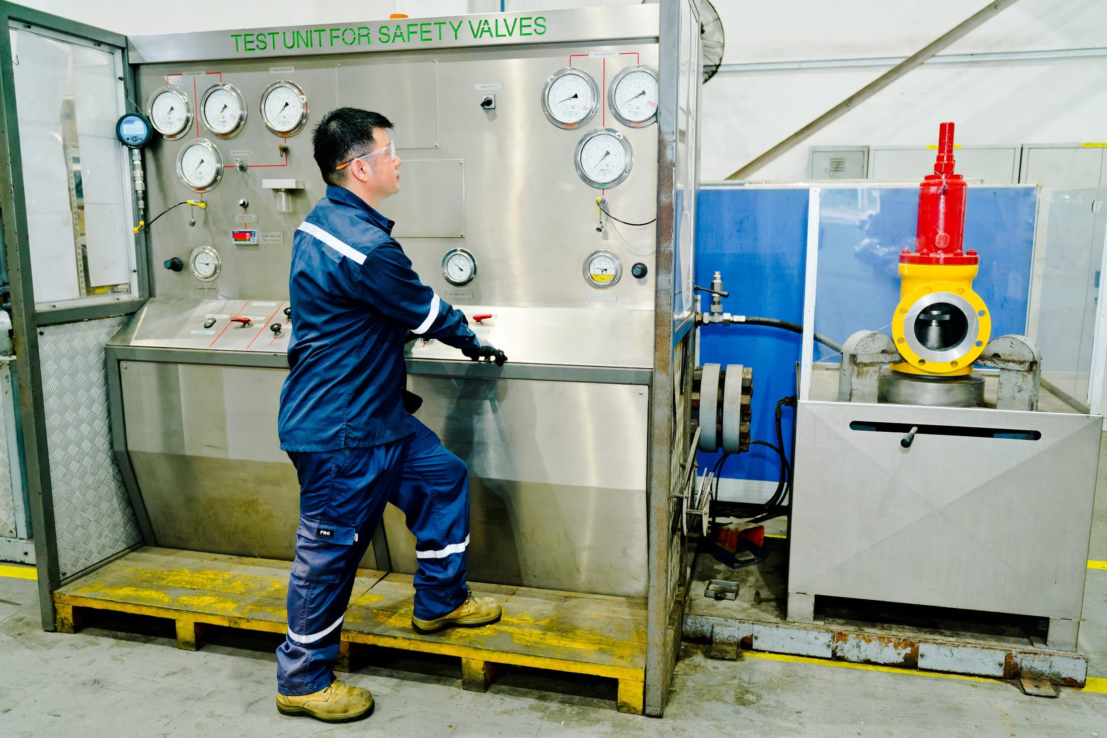 Exion technician operating the safety valve test unit in the workshop